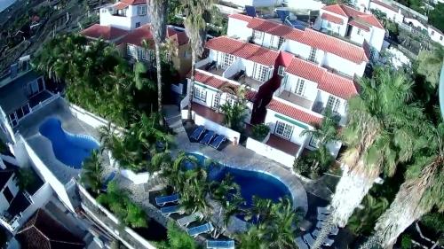 uma vista aérea de um resort com uma piscina em Apartamentos colon y bungalows em Los Quemados