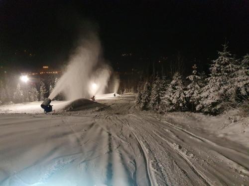 a pile of snow on a snowy road at night at Villa Olimpijska 2 - Centrum in Wisła