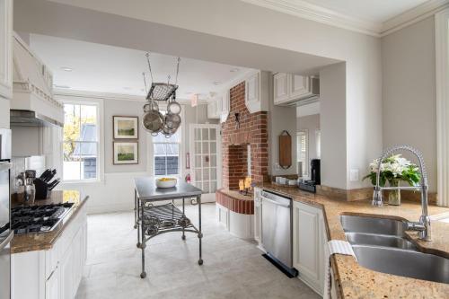 a kitchen with a table and a counter top at 134 Prince - Luxury Boutique Hotel in Annapolis
