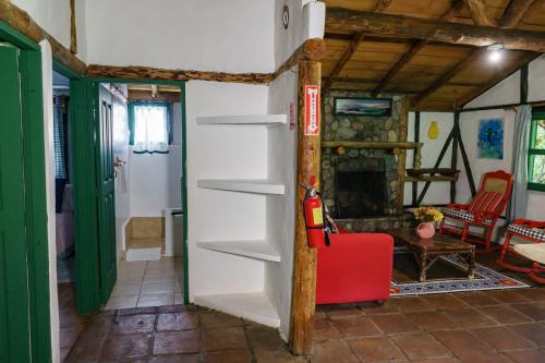 a living room with a fireplace and a fire hydrant at Villa Pajon Eco Lodge in Constanza