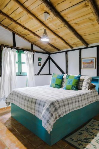 a bedroom with a bed in a room at Villa Pajon Eco Lodge in Constanza