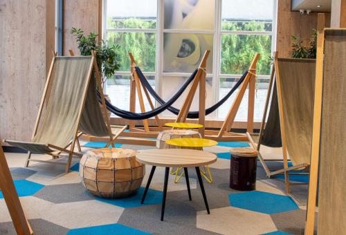 a room with hammocks and a table and a barrel at ibis Sao Paulo Tatuape in Sao Paulo