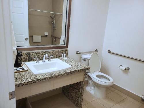 a bathroom with a sink and a toilet at Exchange Club Motel in Beatty