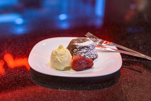 a plate of food with a strawberry and ice cream at ibis Sao Paulo Tatuape in Sao Paulo