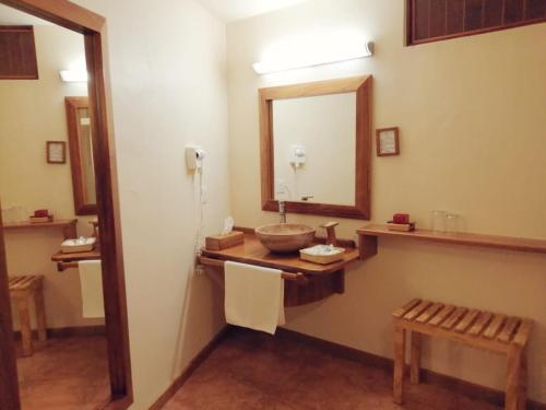 a bathroom with a sink and a mirror at Casa Tsaya Hotel Boutique in Bernal