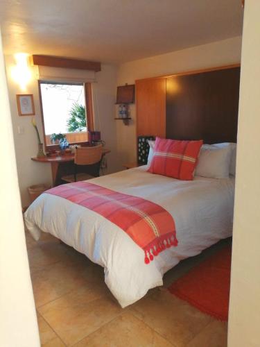 a bedroom with a large bed and a desk at Casa Tsaya Hotel Boutique in Bernal