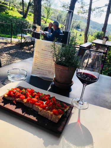 a table with a plate of food and a glass of wine at Casa Panzano Tuscany in Panzano