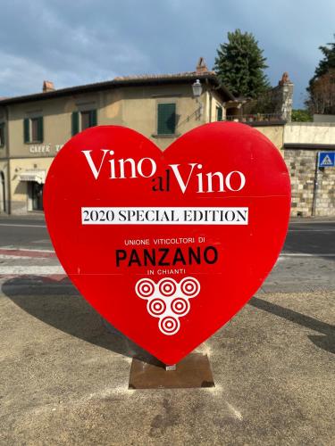a red heart shaped sign in a parking lot at Casa Panzano Tuscany in Panzano