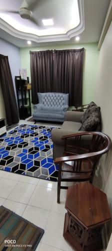 a living room with a couch and a table at Cikgu Azue Homestay in Ampang