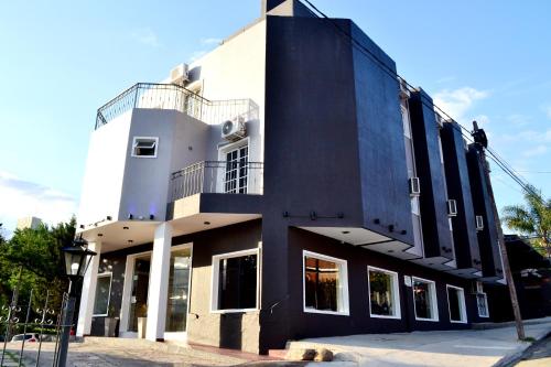 a black and white building on a street at Hotel Terrazas by CPH in Villa Carlos Paz