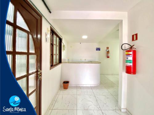 a room with a fire hydrant next to a door at Pousada Santa Monica in Guarapari