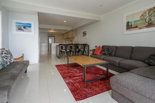 a living room with a couch and a table at Pandanus Palms Holiday Resort in Point Lookout