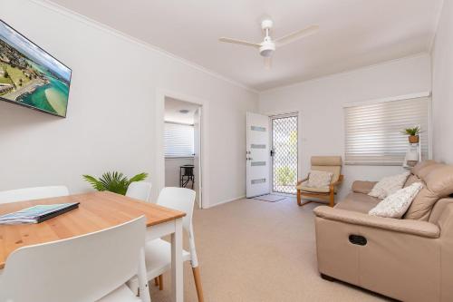 a living room with a table and a couch at Douglas Avenue 5 in Forster