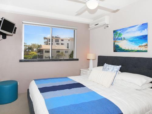 a bedroom with a bed and a window at Broadwater Quays 5 in Mooloolaba