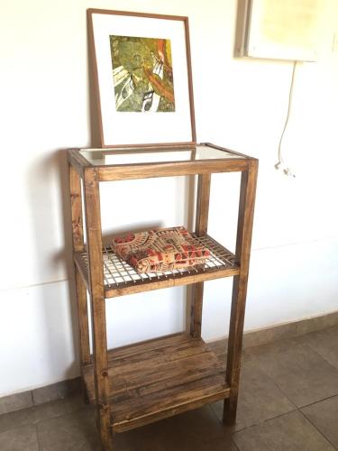 a wooden shelf with a picture on top of it at Posada La Sofia in Tafí del Valle
