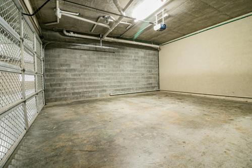 an empty room with a brick wall at Absolute Beachfront Opal Cove Resort in Coffs Harbour