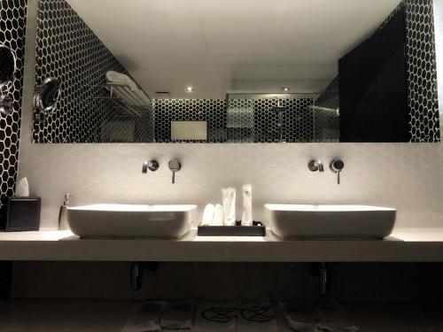 a bathroom with two sinks and a mirror at M Roof Hotel & Residences in Ipoh