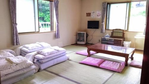 a living room with a couch and a table at ふる郷荘Furusato Furano in Furano