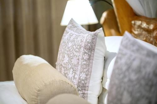 a white couch with pillows and a lamp on it at Leopard Safaris Yala in Yala