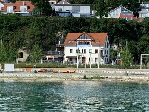 a house sitting on the shore of a body of water at Gästehaus zum Felsen in Überlingen