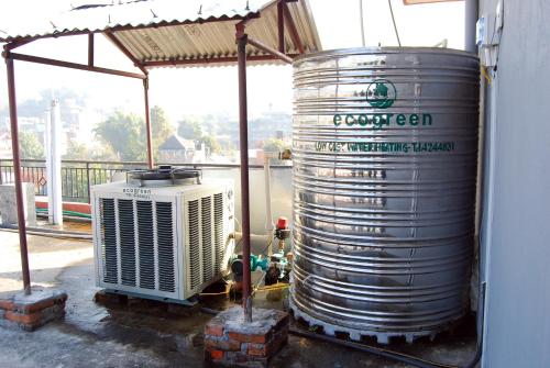 a large tank of water sitting next to a building at Butterfly Lodge in Pokhara