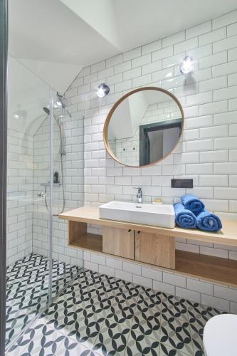 a bathroom with a sink and a mirror at "Parko vila" Anykščiai in Anykščiai