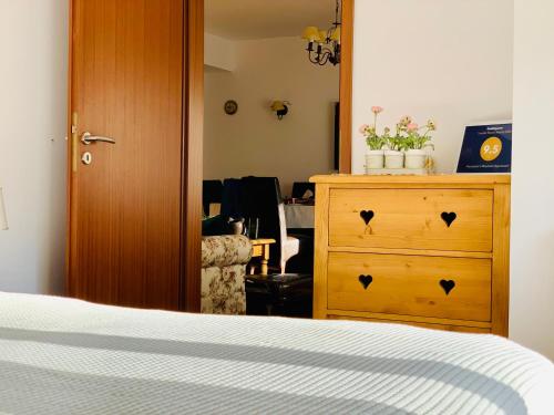 a bedroom with a wooden cabinet and a dresser at Francesco's Mountain Apartment in Predeal