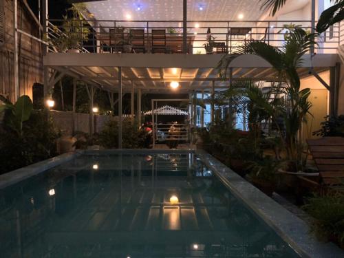 a swimming pool in the middle of a building at Orchid Guesthouse in Phú Quốc