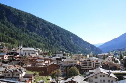 a small town in front of a mountain at Hotel Paradis-Leukerbad-Therme in Leukerbad