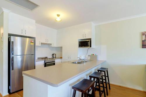 a kitchen with a counter top and a refrigerator at 225 on Myall in Tea Gardens
