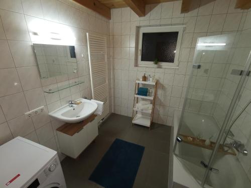 a white bathroom with a sink and a shower at Ferienwohnung Ela in Reutte