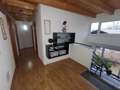 a hallway of a house with white walls and wooden ceilings at Ferienwohnung Ela in Reutte