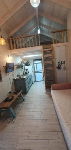 a room with a staircase and a kitchen with a table at Galit's Zimmer in Sha‘alvim