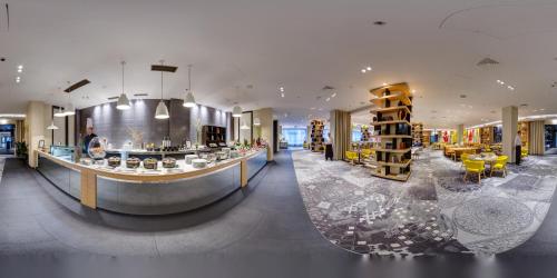 a lobby of a store with a counter and chairs at Sofitel Warsaw Victoria in Warsaw