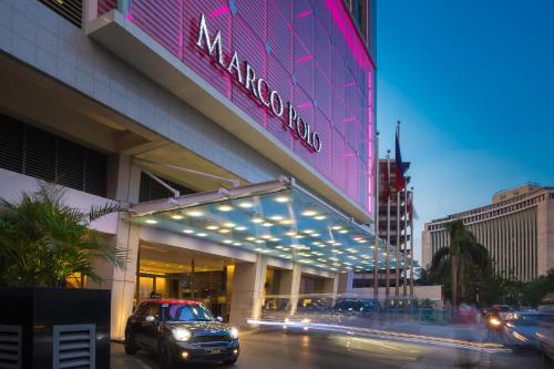 a building with a car parked in front of it at Marco Polo Ortigas Manila in Manila