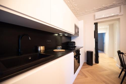 une cuisine avec un évier et un plan de travail dans l'établissement Luxury apartments in Paris Center, à Paris