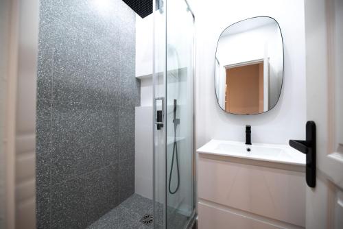 a bathroom with a shower and a sink and a mirror at Luxury apartments in Paris Center in Paris
