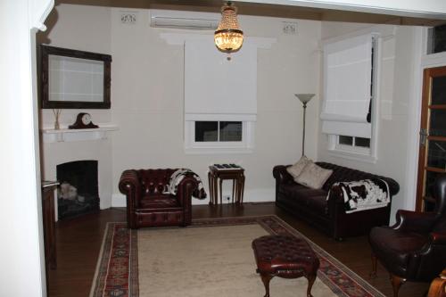 a living room filled with furniture and a fire place at Mentor Chambers Apartment Bed & Breakfast in West Wyalong