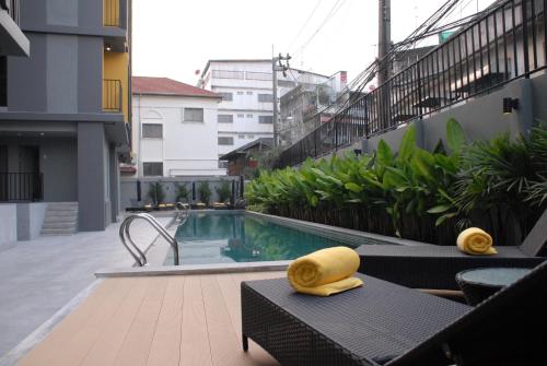 a swimming pool on the side of a building at iSanook Bangkok in Bangkok