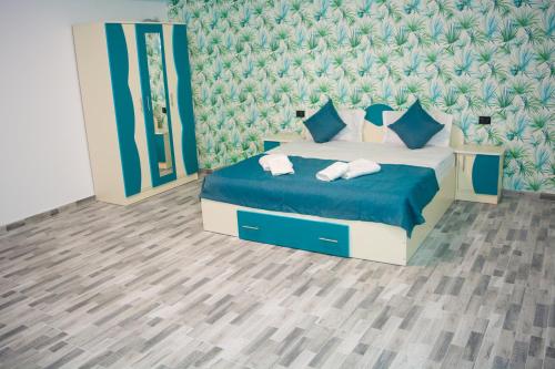a bedroom with a bed with two towels on it at CASA ERk in Călimăneşti