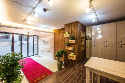 a room with a table and a red rug at Guesthouse The Hill in Seoul