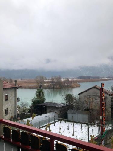 a view of a river with snow on the ground at Hotel Berlinghera in Sorico