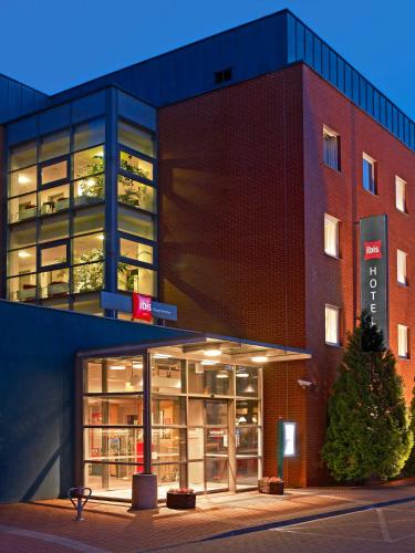 a large brick building with a library in front of it at Ibis Poznan Stare Miasto in Poznań