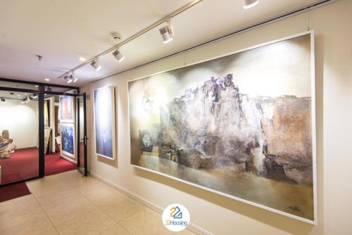 a large painting on the wall in a hallway at 22Housing luxury Hotel & Residence 39 Linh Lang in Hanoi