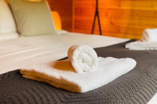 a towel on top of a bed with a towel at Luxury Farm Cabin in the Heart of Wales in Cowbridge