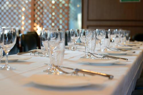 a long table with wine glasses and plates on it at Hotel JAL City Sendai in Sendai