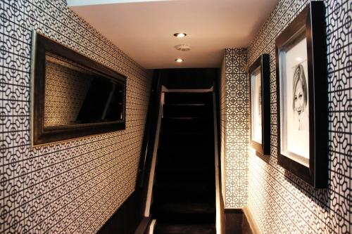 a staircase in a room with a wall covered in tiles at House of Freddy in Amsterdam