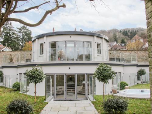 a large white house with large glass windows at Round House in Church Stretton