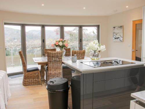 a kitchen with a sink and a table with chairs at Round House in Church Stretton