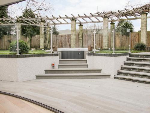 an outdoor amphitheater with stairs and a wooden fence at Round House in Church Stretton